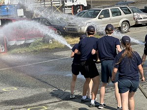 Youths handling hose in fire training